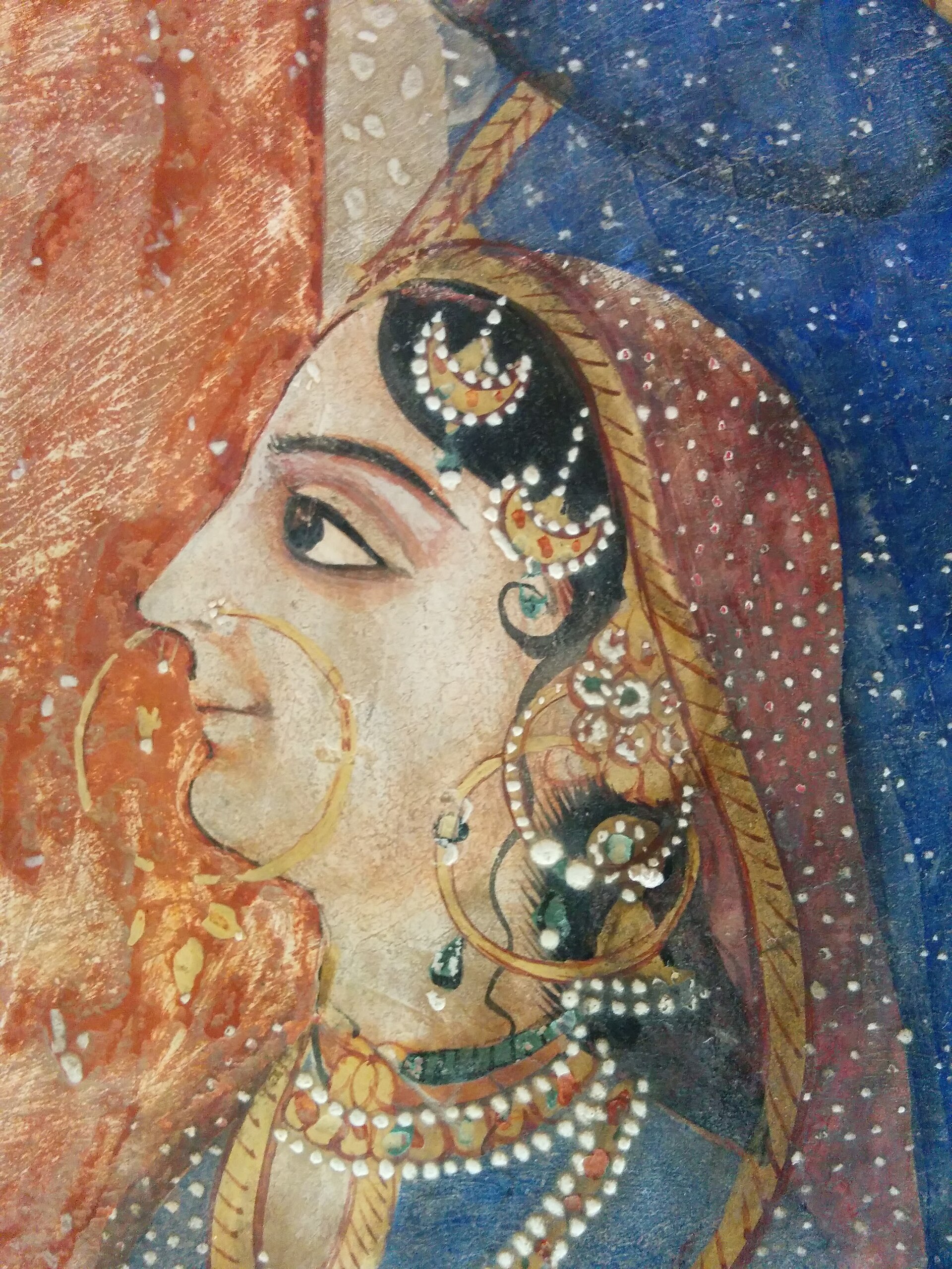 Indian Miniature Painting | Stylo Aunty A detailed indian miniature painting shows a woman with jewelry and a veil, reflecting traditional desi art.