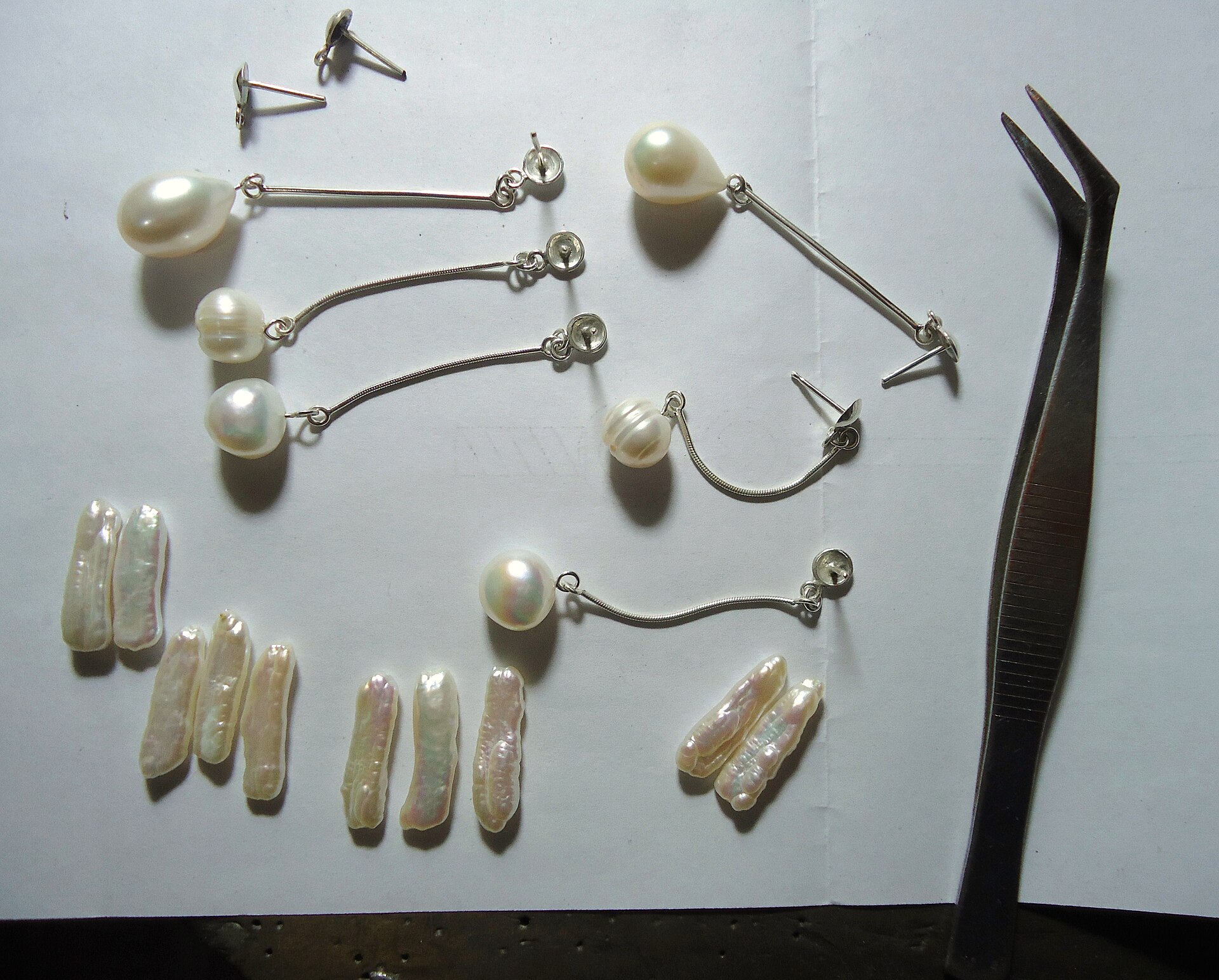 Pearls | Stylo Aunty Jewelry making components like pearls and silver wire are shown, relating to desi fashion accessories.